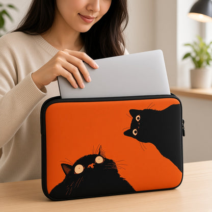 Two Black Cats on a Bright Orange Laptop Sleeve