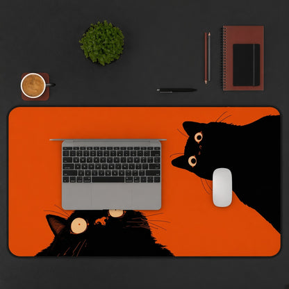 Two Black Cats on a Bright Orange Desk Mat