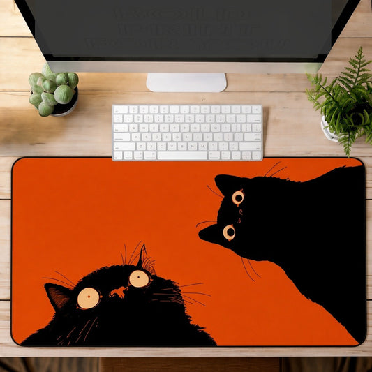 Two Black Cats on a Bright Orange Desk Mat